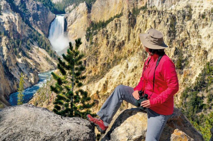 A tourist looking at the Lower Falls at Yellowstone National Park.