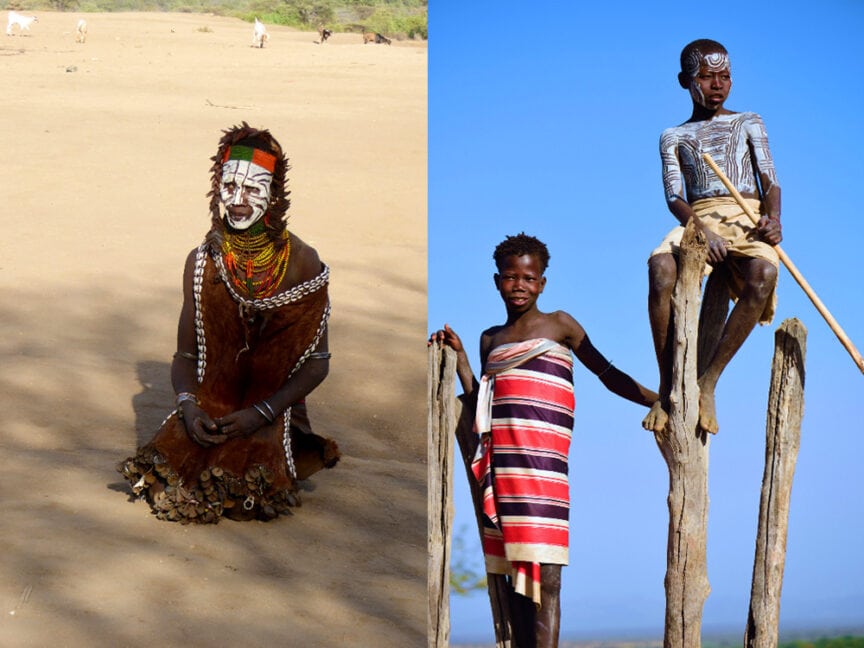 Two individuals: one seated and Karos adorned with face paint and traditional jewelry on the left, and two standing on wooden poles with traditional attire and body paint on the right, in a desert landscape.