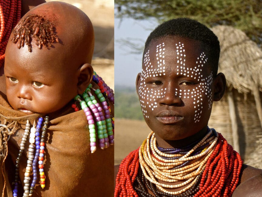 Two people in traditional attire. On the left, a baby adorned with beads and braided hair. On the right, a person with beaded necklaces and white face paint. The Karos individuals stand against a natural background in both images.
