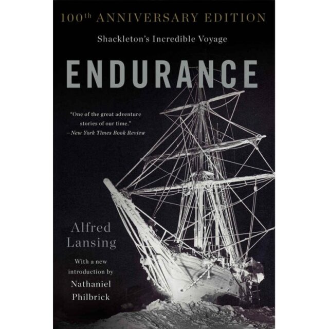 Cover of "Endurance: Shackleton's Incredible Voyage" 100th Anniversary Edition by Alfred Lansing, featuring a photograph of the ship Endurance trapped in ice, with a quote from The New York Times Book Review. A must-read among Adventure Books celebrating one of history's most gripping expeditions.