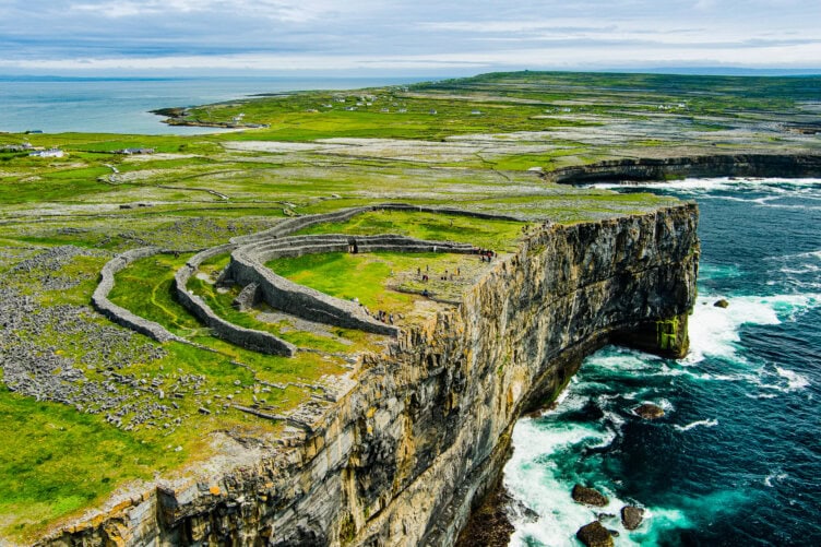 Aerial view of Dun Aonghasa, an ancient stone fort on Inishmore Island, Ireland. Perched on a steep 100-meter cliff overlooking the Atlantic Ocean, this iconic site is among the top things to do when visiting Ireland.