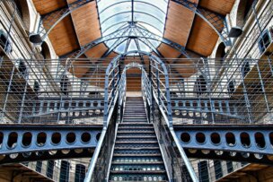 Explore the interior of this historic Dublin landmark, featuring a majestic central staircase with intricate metal railings and an arched glass ceiling. A must-see on your travel itinerary, it's among the top things to do when visiting this enchanting city.