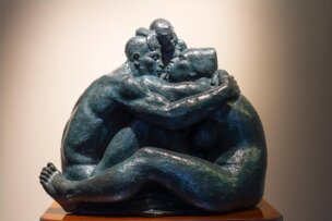 Bronze sculpture of three figures in a tight embrace, a notable sight for those planning things to do in San José.